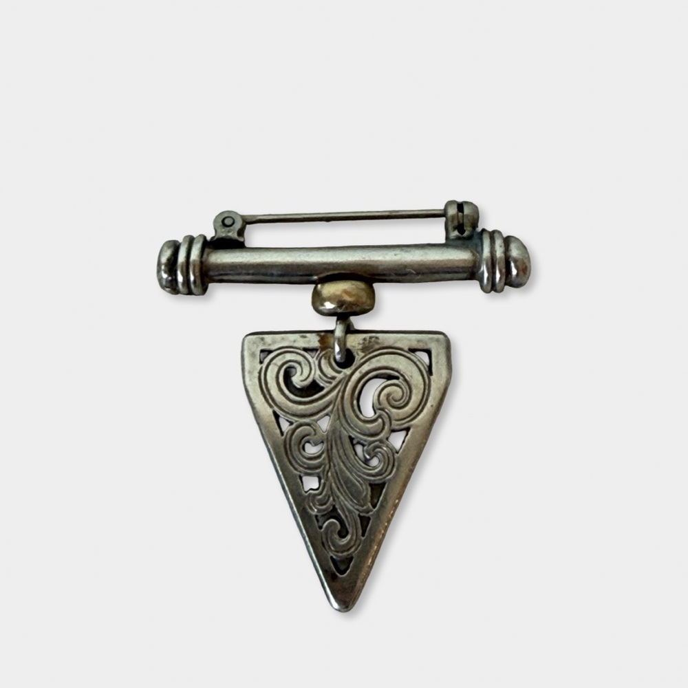 Vintage brooch crafted in sterling silver with 14K gold accent